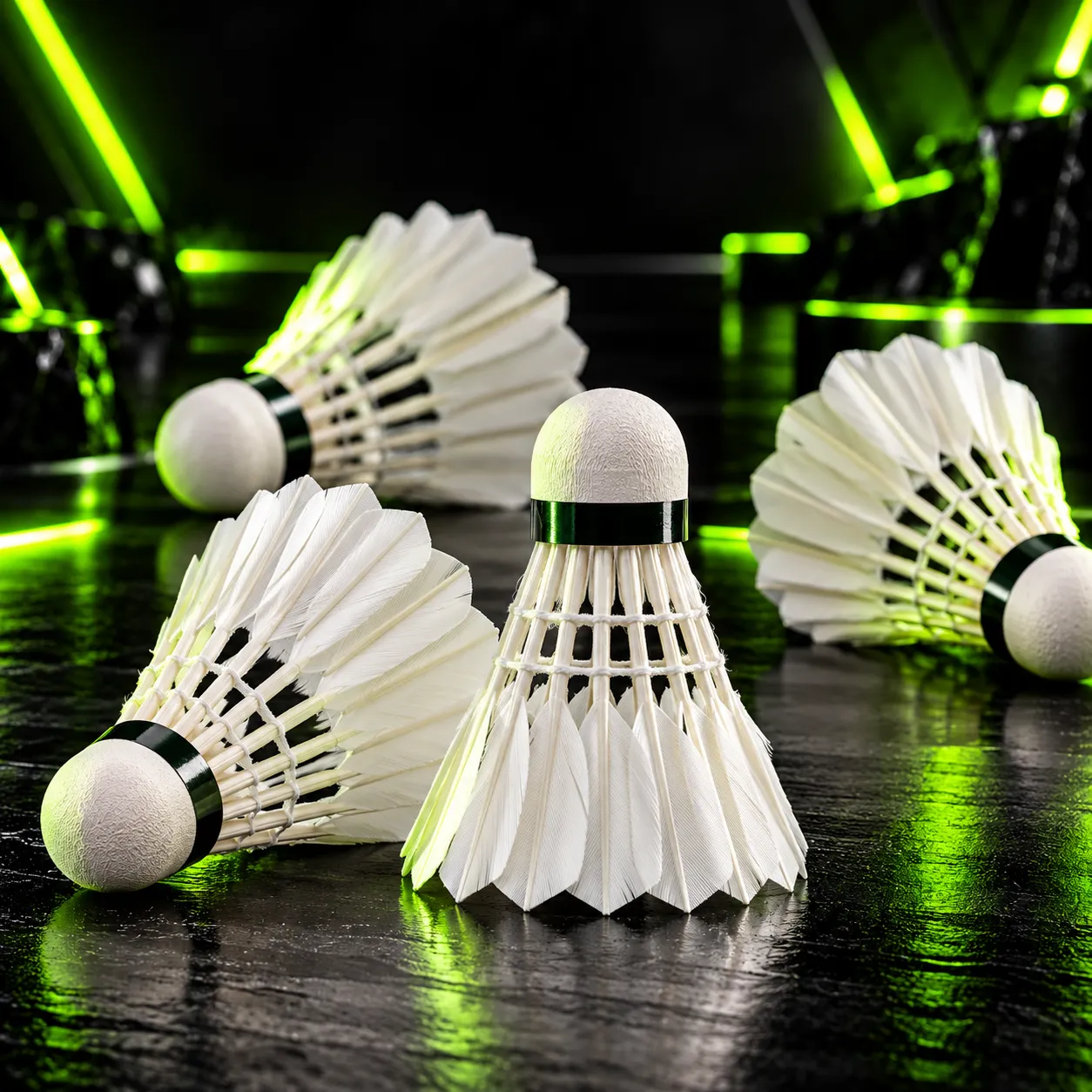 Feather badminton shuttlecocks on a dark reflective surface